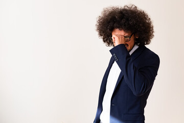 Latin American model in a suit, disappointed expression, white background 