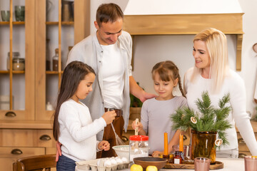 Happy family having fun at home, family cooking before christmas