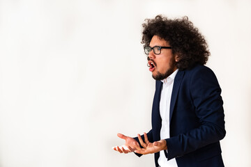 Latin American model in a suit, unhappy expression, white background 