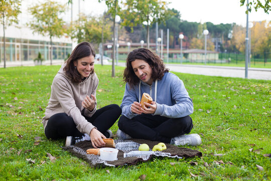 two university students having picnic at the school campus