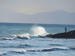Fisherman in front of the sea. 
