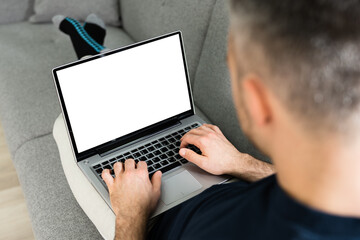 Guy Sitting On Sofa Using Laptop