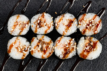Sushi Rolls Set, maki, philadelphia and california rolls, on a Black background.