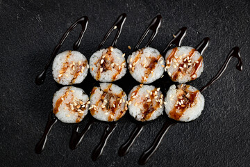 Sushi Rolls Set, maki, philadelphia and california rolls, on a Black background.