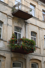 Fototapeta na wymiar Balcony with flowers in old building