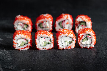 Sushi Rolls Set, maki, philadelphia and california rolls, on a Black background.