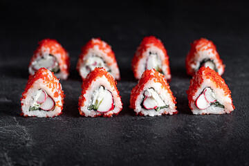 Sushi Rolls Set, maki, philadelphia and california rolls, on a Black background.