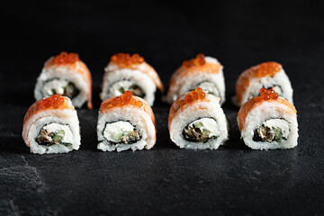 Sushi Rolls Set, maki, philadelphia and california rolls, on a Black background.