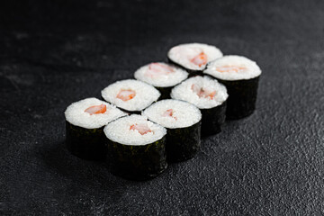 Sushi Rolls Set, maki, philadelphia and california rolls, on a Black background.