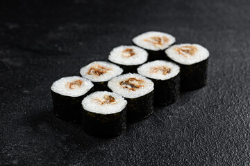 Sushi Rolls Set, maki, philadelphia and california rolls, on a Black background.