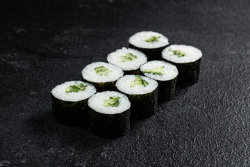 Sushi Rolls Set, maki, philadelphia and california rolls, on a Black background.