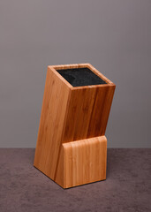 Wooden knife block on grey background 