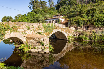 Fototapeta na wymiar Roman bridge of Arco over Vizela river in Burgo village, Vila Fria (Felgueiras), Porto District, Portugal