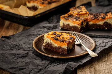 Delicious pumpkin cake with cheese cream and cacao or chocolate on the top