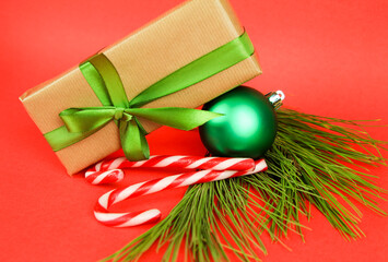 Gift with Christmas decoration on red background