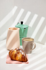Homemade almond croissant and coffee