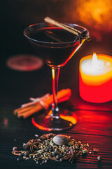 Red hot drink glintwein with spices, cinnamon, anise, fruits, brown sugar on an old wooden table. New Year and Christmas holidays concept. Mulled wine and glintwein.