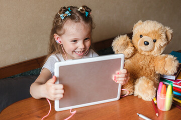 Schoolgirl studying math during her online lesson at home, Self-isolation, online education concept