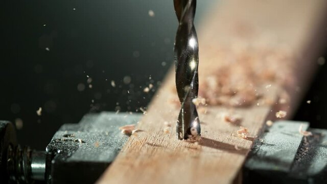 Super slow motion of detail of a drill bit drilling into wood. Filmed on high speed cinema camera, 1000 fps.