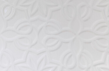 white wall background with various forms of ornamentation