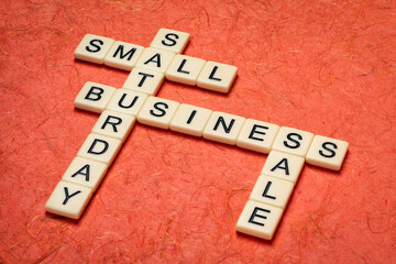 small business Saturday - crossword against handmade mulberry paper, holiday shopping concept