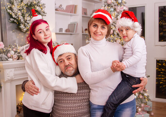 New Year's photo session of a family in which there is a boy with Down syndrome, a disabled child,...