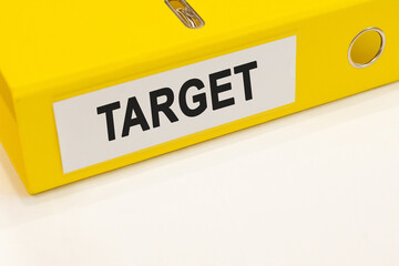 The word target on a white background with a yellow folder. Business concept