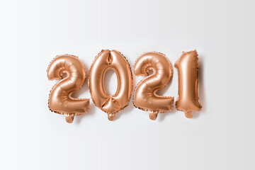 2021 gold New Year foil party ballons. Christmas celebration. Creative flat lay background. Minimal holiday concept.