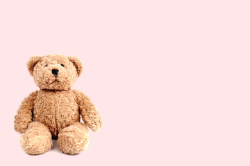 Teddy bear on bright pastel pattern background. Minimal pink compostition. Soft toy concept.