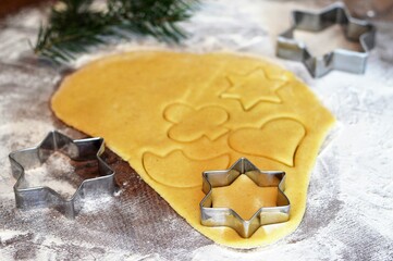  Preparing Christmas gingerbread cookies. Christmas cookie cutters and cookie dough. - Powered by Adobe