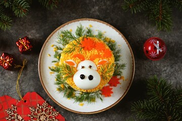 Traditional festive Russian salad Mimosa - in the form of a cute bull symbol of 2021.