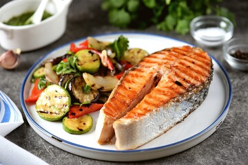 Grilled salmon steak with grilled salad of zucchini, eggplant, bell peppers, onions, garlic, cilantro, olive oil and wine vinegar.