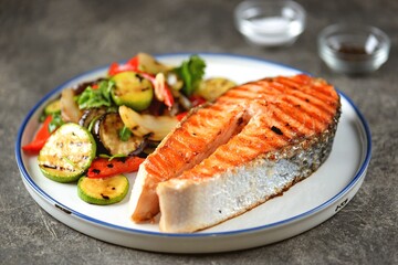 Grilled salmon steak with grilled salad of zucchini, eggplant, bell peppers, onions, garlic, cilantro, olive oil and wine vinegar.