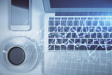 Stock market chart and top view computer on the table background. Multi exposure. Concept of financial analysis.