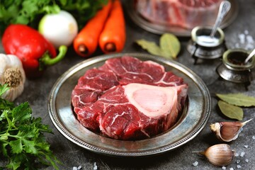 Raw beef shank with vegetables and garlic.
