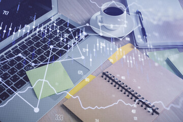 Multi exposure of forex graph drawing and desktop with coffee and items on table background. Concept of financial market trading