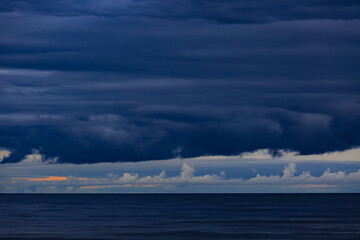 Dramatic clouds against the background of dark water