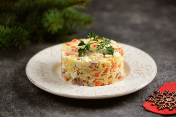 Festive salad with salted herring, boiled potatoes, eggs, onions and carrots.