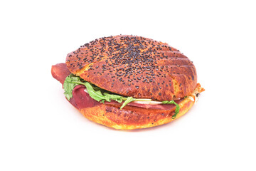 Round sandwich known as medaglione with bresaola, salad and parmesan cheese, a classic filling in Italian bars, cafe or coffee shops. Bread with sesame seeds on top. Isolated on white.