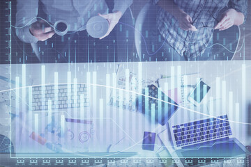 Double exposure of man and woman working together and financial chart hologram drawing. market analysis concept. Computer background. Top View.