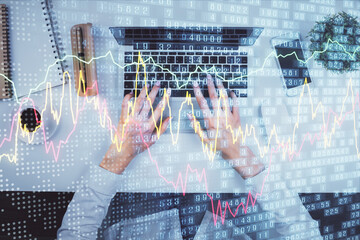 Double exposure of woman hands working on computer and forex chart hologram drawing. Top View....