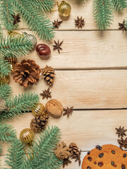 Christmas background with spruce branches, Christmas toys, cones, cookies, nice warm soft light. Christmas background on wooden white boards with copy space