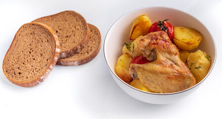 Fresh Baked potatoes with chicken pieces tomatoes on a plate