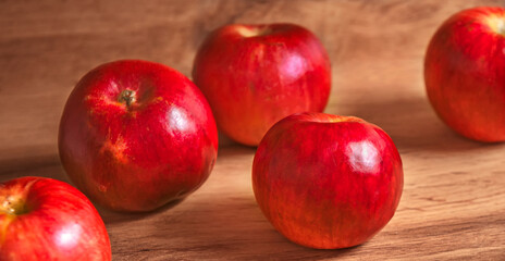 Fresh red delicious apples on a wooden table