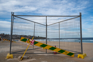 Fenced off area at the beach, due to maintenance work being done on the footpath.