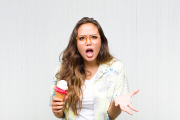 young hispanic woman looking angry, annoyed and frustrated screaming wtf or what’s wrong with you