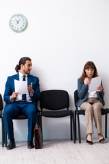 Obraz premium Young businessman and businesswoman waiting for an interview at