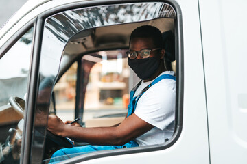 Naklejka premium Young Afro-American or African male working in everyday or daily home delivery service.