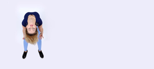 A girl with blonde hair and closed eyes doing a strange gymnastics and yoga movement