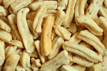 Ganthiya (Fried spicy chickpea flour sticks). View from above on sticks pile. Closeup